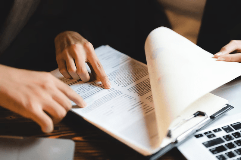 Hands reviewing Zoiko iD technical specification document