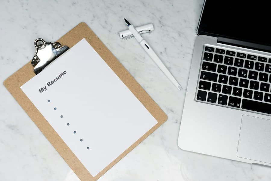 Documentation workspace with resume clipboard and laptop