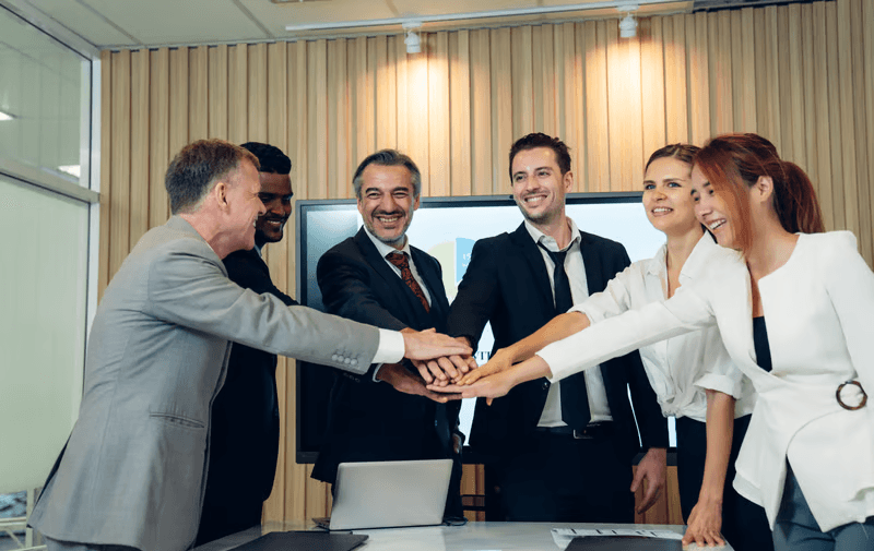 Colleagues stacking hands in collaboration