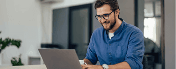 Man working on laptop with glasses