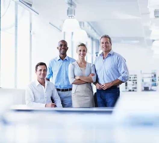 Smiling team standing together in a bright office