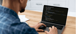 Person coding on laptop