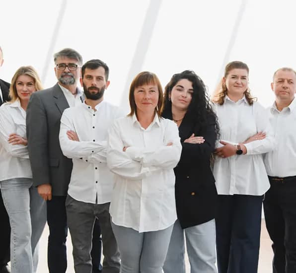 Team of colleagues standing together with arms crossed