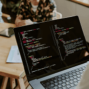 Laptop displaying code on a desk