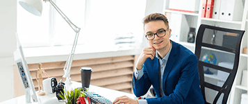 Professional sitting at a desk smiling