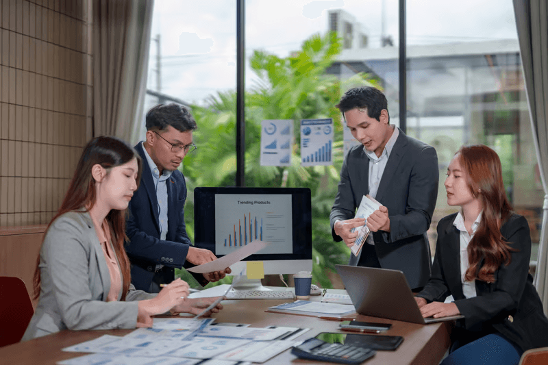 Financial advisors and analysts reviewing transaction authorization