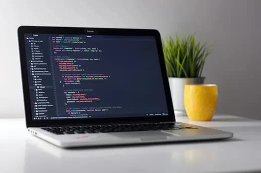 Application developer coding on a laptop