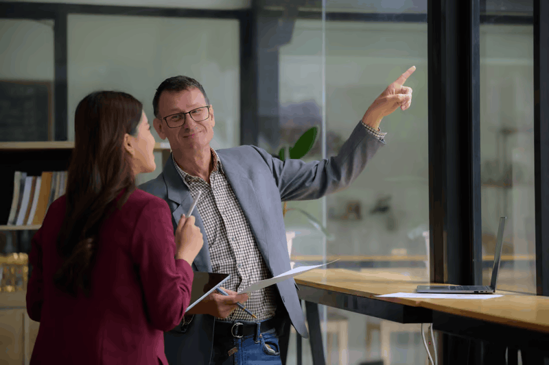 Colleagues pointing at screen during architecture review